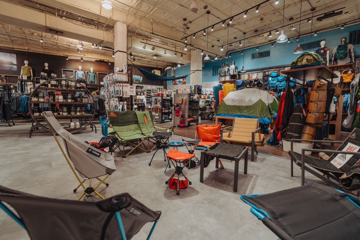 Store interior with camping furniture and equipment on display