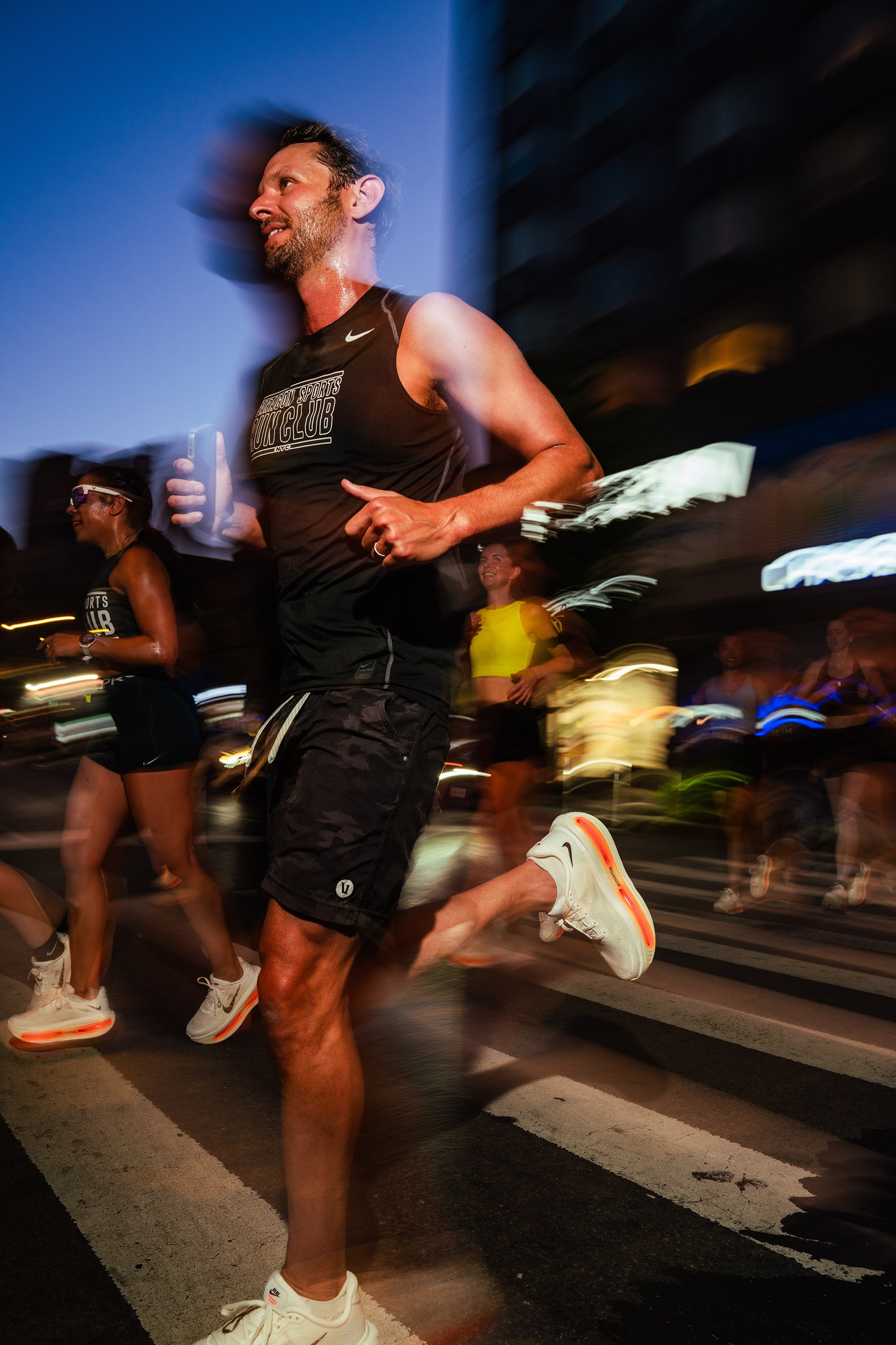 Person running on a city street at night with blurred background