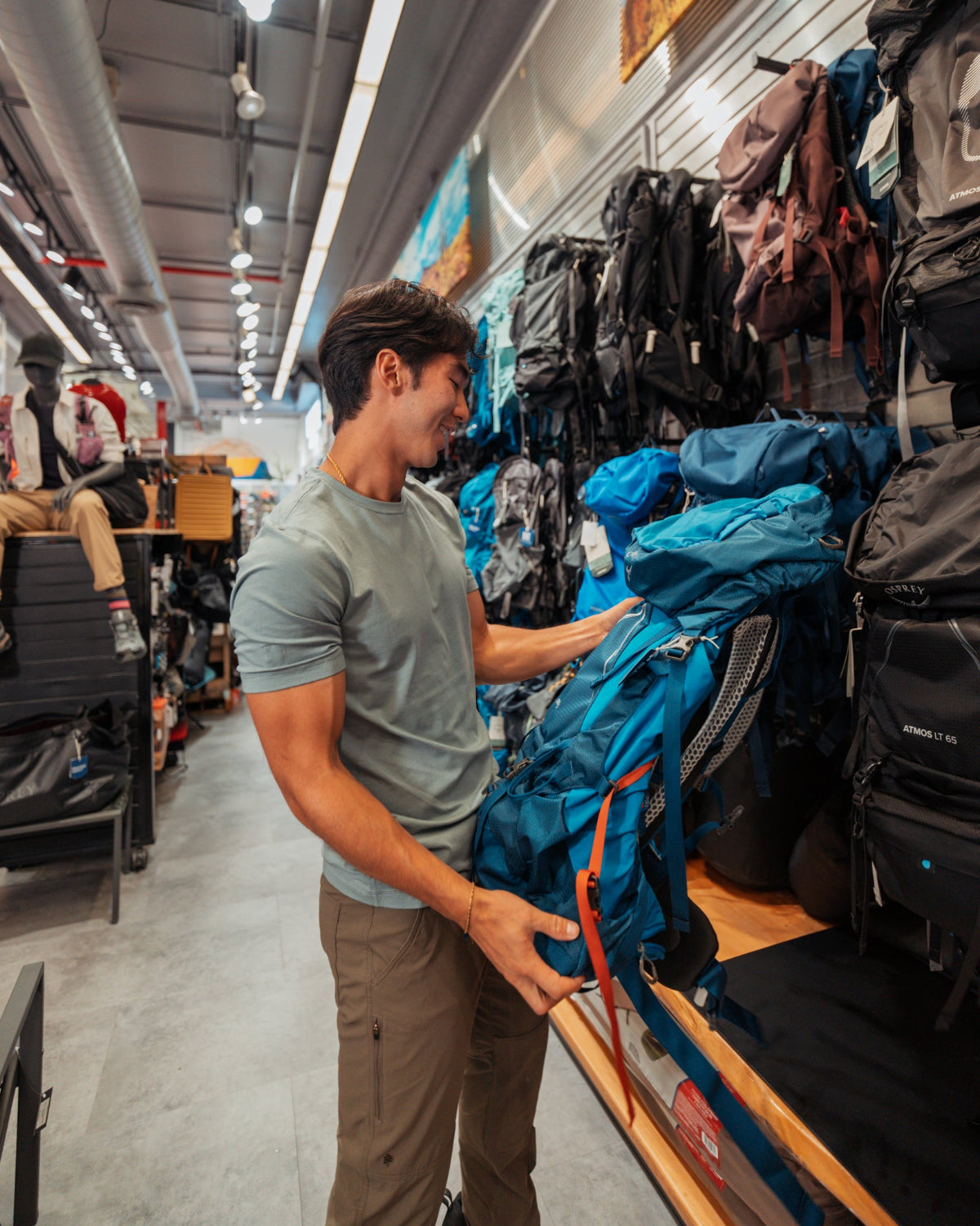 man with a pack in the camping shop