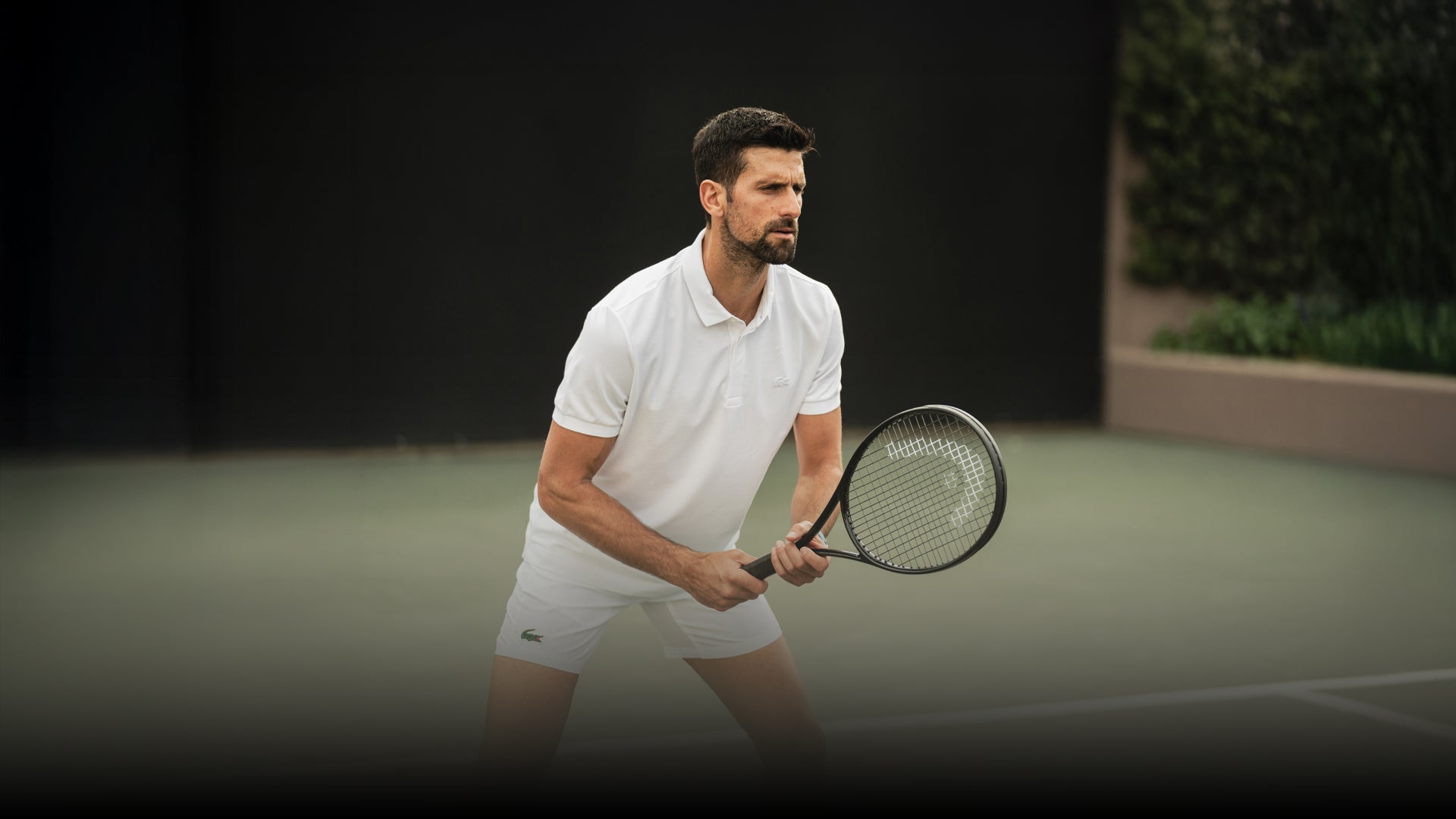 Djokovic playing tennis on a court with a blurred background photo by Head
