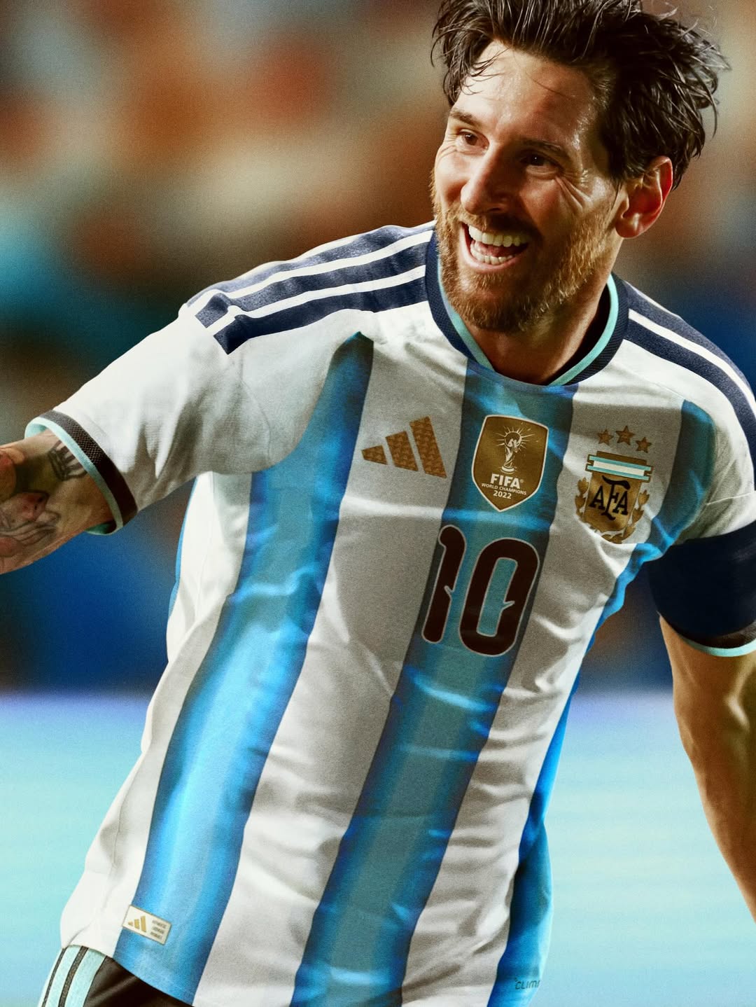 Messi wearing an Argentina soccer jersey with a blurred background