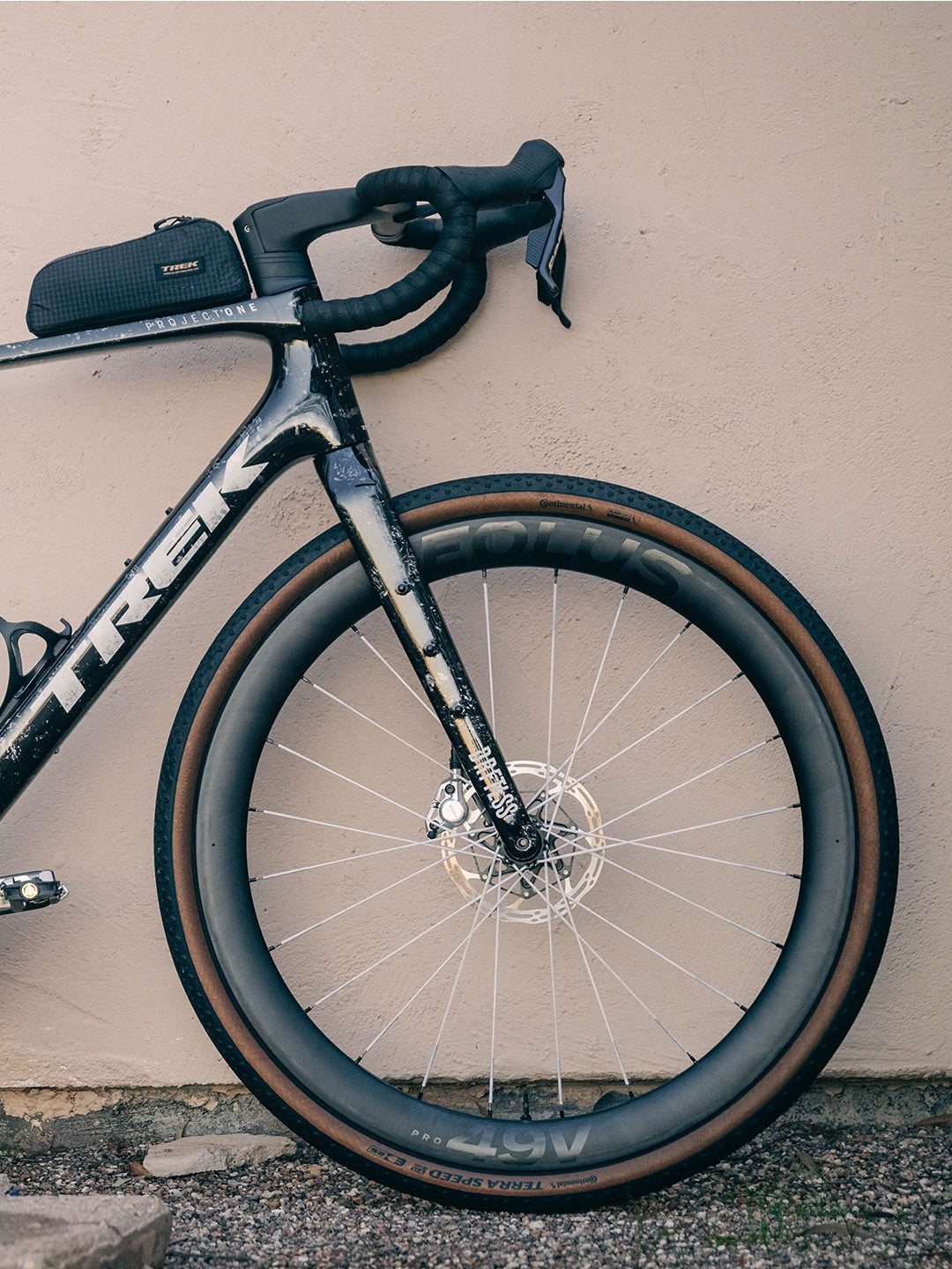 Trek bicycle leaning against a beige wall