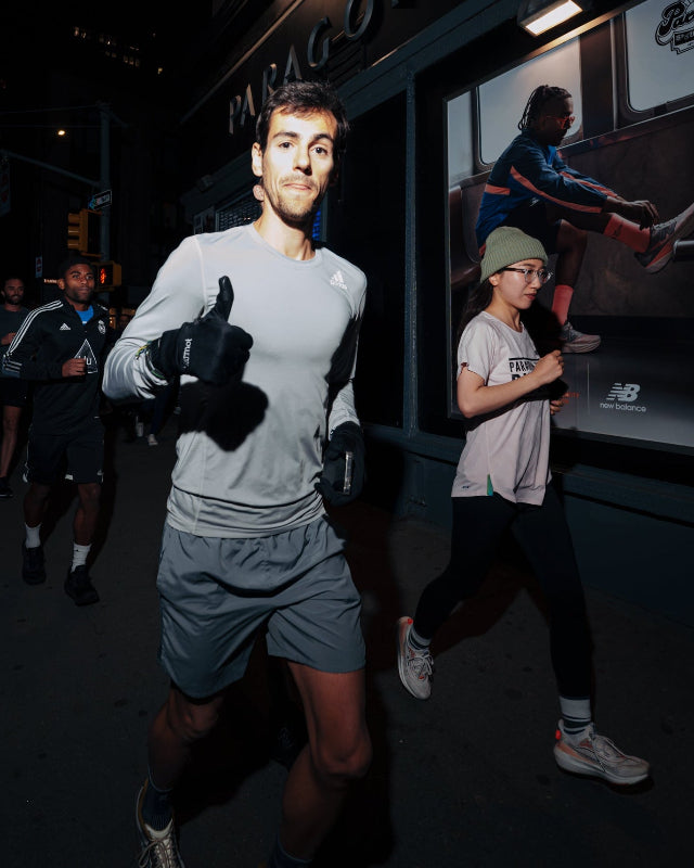 Person running at night with a sports truck in the background photo by jose crespof
