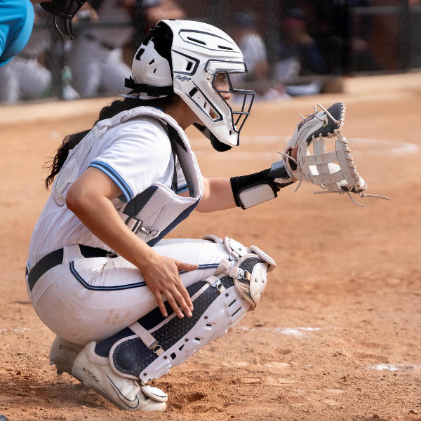 Softball catcher in full gear on a softball field